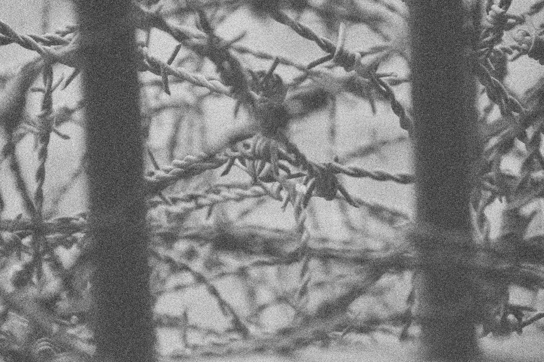 Barbed wire behind railings